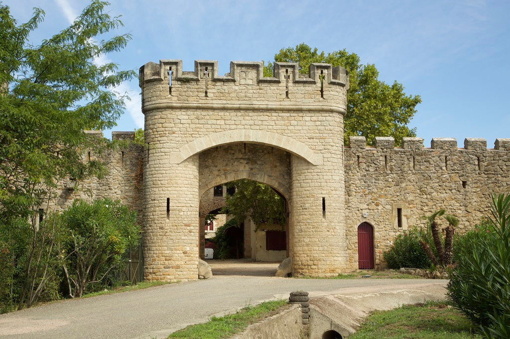 Château Grézani kivivärav ja sakmelised müürid Laurens’is Languedocis
